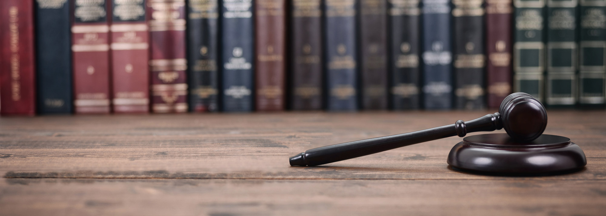 Law books lined side-by-side behind a gavel