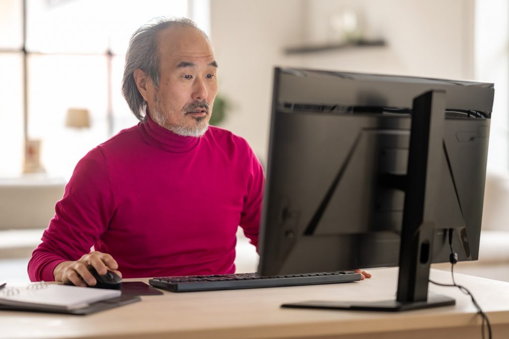 Elderly man at computer