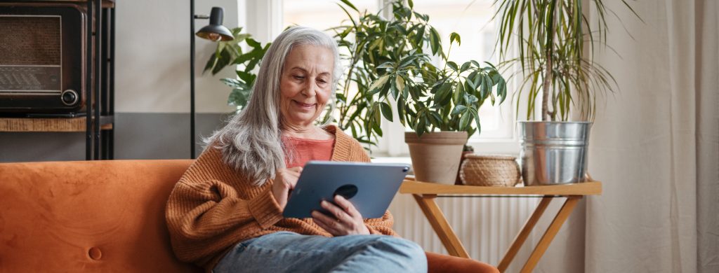 Senior woman spending her leisure time with a digital tablet