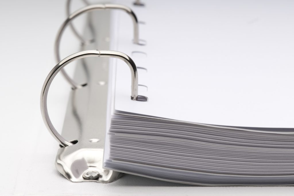 Open binder with documents.