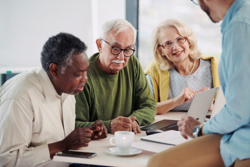 Group of seniors looking at laptop